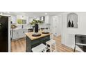 Modern kitchen with white cabinets, butcher block island, and stainless steel appliances at 300 Cherry St, Belmont, NC 28012