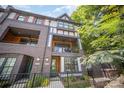 Stately three-story home featuring brick accents, balconies, and a well-manicured yard at 3026 Kalex Ct, Charlotte, NC 28204