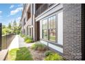 Modern home with a brick facade, well-kept lawn, and large windows at 3026 Kalex Ct, Charlotte, NC 28204
