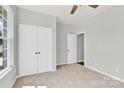 Serene bedroom with carpet, a ceiling fan, double door closet, and a window offering natural light at 3207 Selwyn Landing Dr, Charlotte, NC 28215