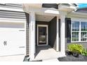 Inviting front entrance featuring white columns and a black front door, showcasing a welcoming facade at 3207 Selwyn Landing Dr, Charlotte, NC 28215