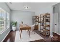 Bright home office with hardwood floors, large window, wooden desk, and decorative shelving unit at 321 Almora Loop, Mooresville, NC 28115