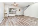 Inviting living room featuring light hardwood floors, neutral walls, and a ceiling fan at 3561 Calpella Ct, Charlotte, NC 28262