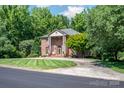 Beautiful brick home boasts mature landscaping and a welcoming front entrance at 408 Johnsfield Rd, Shelby, NC 28150