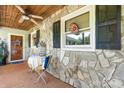 Cozy covered front porch with stone accents and charming decor at 4395 Burton Rd, Maiden, NC 28650