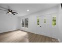 Bright bedroom boasts neutral walls, wood-look floors, and a large window plus an exterior door for ample natural light at 442 Lovelace Rd, Rock Hill, SC 29730
