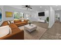 Cozy living room featuring a comfortable sofa, a stylish area rug, and windows offering views of the outdoors at 442 Lovelace Rd, Rock Hill, SC 29730