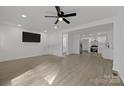 Open-concept living space with wood-look flooring, recessed lighting, and seamlessly connected to a modern kitchen at 442 Lovelace Rd, Rock Hill, SC 29730