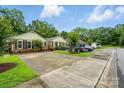 Street view showcasing well-maintained brick homes with driveways and manicured lawns at 656 Ne Camrose Ne Cir, Concord, NC 28025