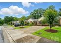 A street view of multiple, charming brick homes with well-kept lawns and driveways at 656 Ne Camrose Ne Cir, Concord, NC 28025