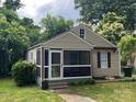 Inviting exterior showcasing a screened porch, well-maintained siding, and lush greenery surrounding the property at 659 Annafrel St, Rock Hill, SC 29730