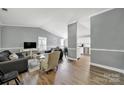 Open-concept living room with modern decor, hardwood floors, and plenty of natural light at 6705 Reddman Rd, Charlotte, NC 28212