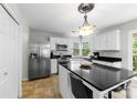 Kitchen with white cabinets, stainless steel appliances, kitchen island with seating, and granite countertops at 7425 Hubbard Woods Rd, Charlotte, NC 28269