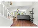 Bright living room with hardwood floors, open layout, and a staircase at 7425 Hubbard Woods Rd, Charlotte, NC 28269