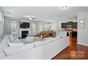 Open-concept living space with hardwood floors, a fireplace, and seamless connection to dining and kitchen at 78114 Rillstone Dr, Lancaster, SC 29720