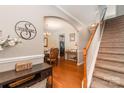 Inviting foyer with hardwood floors, staircase and elegant decor, creating a warm and welcoming entrance at 10237 Broken Stone Ct, Charlotte, NC 28214
