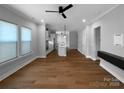 Spacious living area featuring hardwood floors and open-concept design to the kitchen at 11211 James Coy Rd, Huntersville, NC 28078