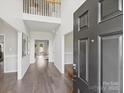 Inviting foyer with dark wood flooring, soaring ceilings, and bright neutral paint at 11332 Anna Rose Rd, Charlotte, NC 28273