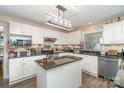 Bright kitchen features white cabinets, granite countertops, and an island at 135 Oak Creek Dr, Rockwell, NC 28138