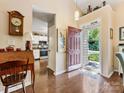 Inviting home foyer with hardwood floors, high ceiling, and view to the kitchen at 13600 Seastone Ln, Pineville, NC 28134