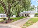 Lovely one story home on a spacious lot with a long driveway and mature shade trees at 13600 Seastone Ln, Pineville, NC 28134