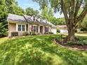 Beautiful single-story home with well-manicured lawn, mature shade trees, and charming curb appeal at 13600 Seastone Ln, Pineville, NC 28134