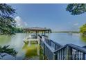 Picturesque boat dock featuring a covered slip and tranquil lake views at 18205 Royal Oak Rd, Charlotte, NC 28278