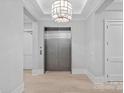 Hallway featuring hardwood floors, recessed lighting, and an elevator at 19329 Watermark Dr # 422, Cornelius, NC 28031