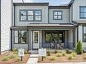 Modern two-story home with gray siding, dark framed windows, and a charming front porch at 223 Halemarg Dr, Belmont, NC 28012