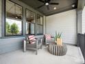 Cozy front porch with modern seating arrangement and view of lush greenery at 223 Halemarg Dr, Belmont, NC 28012