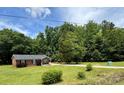 Charming single-story home with a well-manicured lawn and mature trees, offering serene curb appeal at 232 Harmony Hills Dr, Catawba, SC 29704