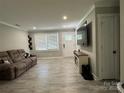 Bright living room with neutral walls, hardwood floors, large windows, and comfortable couch at 232 Harmony Hills Dr, Catawba, SC 29704