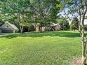 Sprawling green lawn surrounds a beautiful home with a detached garage, offering ample outdoor space at 234 Rivercliff Dr, Stony Point, NC 28678
