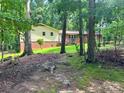 View of the exterior of home with brick and siding, nestled among mature trees at 237 Antietam Rd, Statesville, NC 28625