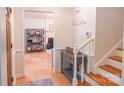Inviting foyer with hardwood floors, staircase, hall tree, and a glimpse into a cozy living room at 3008 Heathcroft Ct, Charlotte, NC 28269