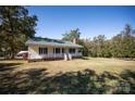 View of a single-story home featuring a front porch, chimney, and a spacious well-maintained yard at 3330 Clinzo Feemster Rd, Hickory Grove, SC 29717