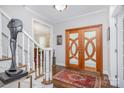 Inviting entryway features a unique wooden double door and hardwood floors, enhancing the home's charm at 345 Beaten Path Rd, Mooresville, NC 28117