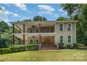 Spacious two-story house features a double porch, ceiling fans and stairs leading to front entrance at 345 Beaten Path Rd, Mooresville, NC 28117
