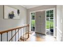 Home foyer with hardwood floors, front door, sidelights, and interior staircase to lower level at 3504 Mountainbrook Rd, Charlotte, NC 28210