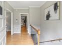Inviting foyer with hardwood floors, neutral walls, staircase, and view into the living area at 3504 Mountainbrook Rd, Charlotte, NC 28210