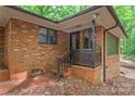 Cozy outdoor patio featuring a brick foundation, wooden railings, and privacy at 3985 Well Rd, Mint Hill, NC 28227