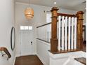 Welcoming foyer with wood flooring, staircase, and stylish light fixture at 402 Belton St, Charlotte, NC 28209
