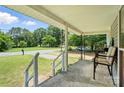 View from covered porch with chairs, greenery, and a view of the street at 407 Rosemont Ave, Kannapolis, NC 28081