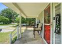View from covered porch with outdoor seating, plus a view of a road and car at 407 Rosemont Ave, Kannapolis, NC 28081