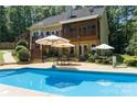 Inviting backyard pool with patio and multiple umbrellas providing shade and relaxation at 6184 Chandler Rd, Clover, SC 29710