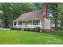 Cozy home with a well-kept lawn and a charming front porch at 6706 Farrington Ln, Charlotte, NC 28227