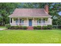 Charming front of house with inviting porch and well-manicured lawn at 6706 Farrington Ln, Charlotte, NC 28227