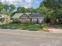 Quaint brick home with well-maintained lawn and mature trees lining the street at 729 Montgomery Ave, Albemarle, NC 28001