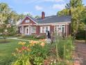 Beautiful brick home with lush flower beds and a welcoming front entry at 729 Montgomery Ave, Albemarle, NC 28001