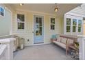 Cozy covered front porch with stylish decor, including lanterns, seating, and a welcoming ambiance at 827 Digby Rd, Rock Hill, SC 29730